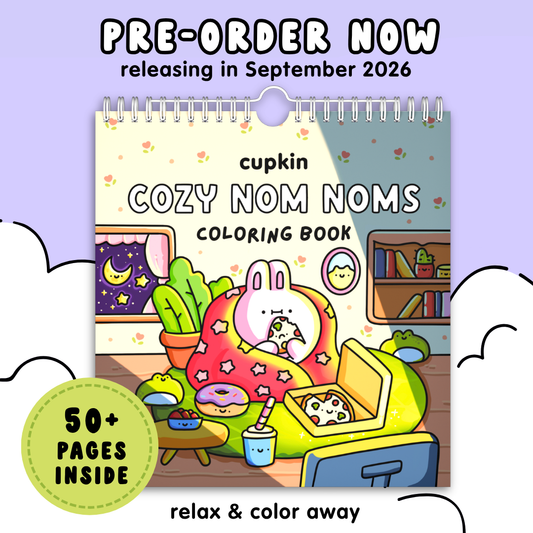 Promotional graphic for the 'cupkin COZY NOM NOMS coloring book' pre-order. The image features a central illustration of a cozy cartoon scene with a bunny in bed, surrounded by text overlays including 'PRE-ORDER NOW', '50+ PAGES INSIDE', and 'relax & color away'.