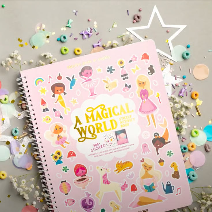 Sticker book titled 'A Magical World' surrounded by colorful stickers and decorative items on a light background.