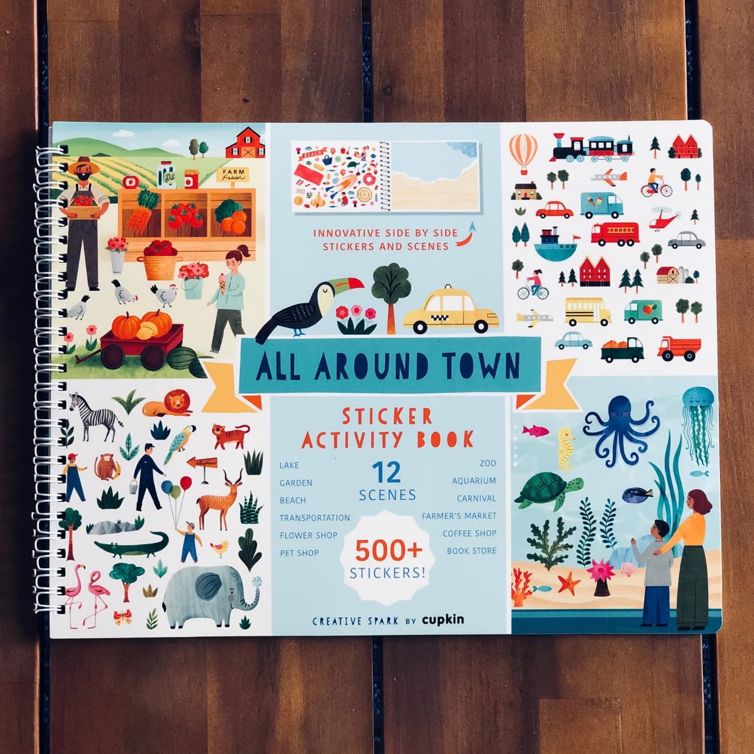 Sticker activity book titled 'All Around Town' by Cupkin on a wooden surface